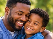 A father and his young son, cheek to cheek
